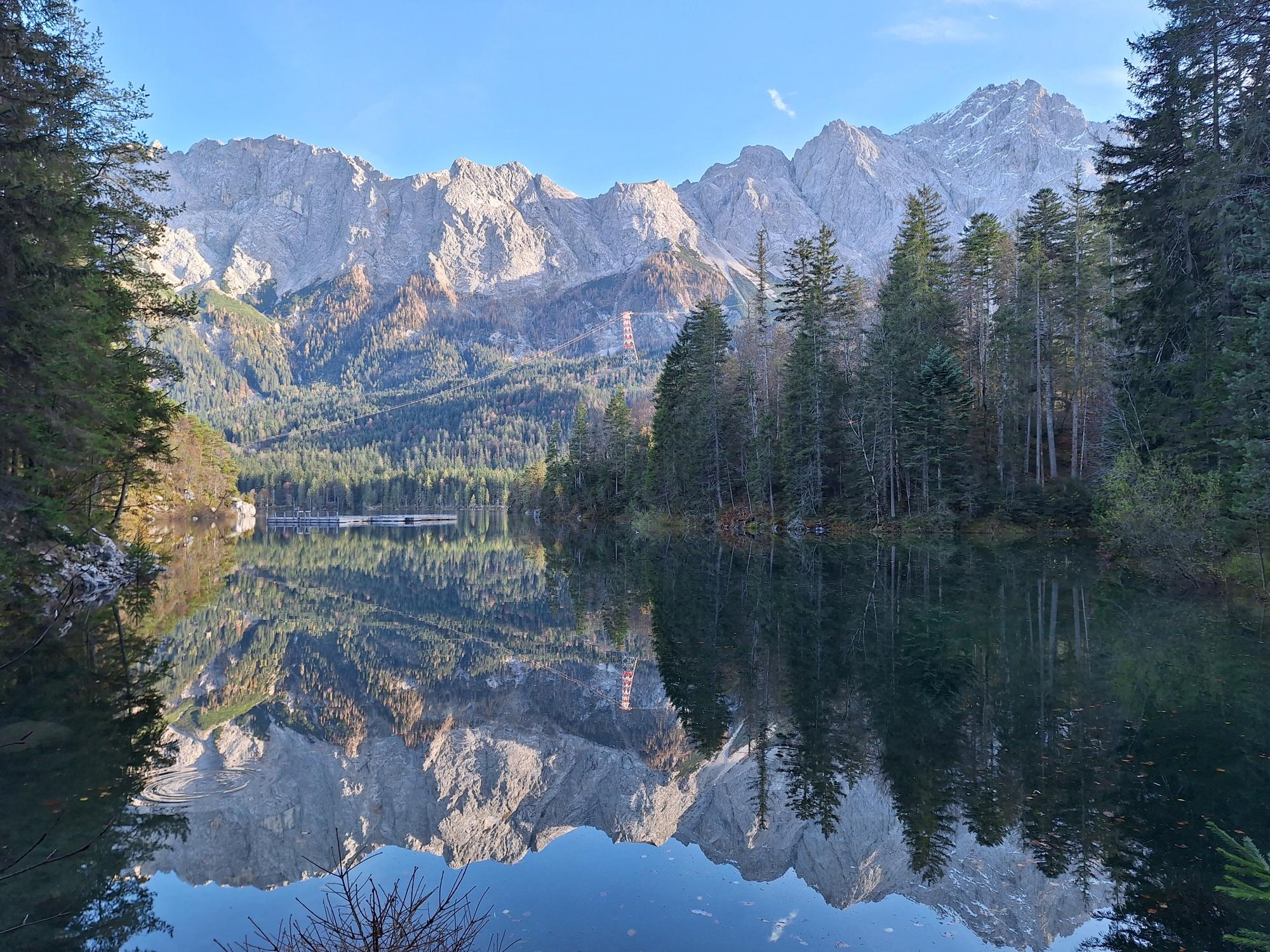 Beautiful reflections of the Zugspitze on the Eibsee.
AI generated caption: Serene mountain landscape reflecting in a calm lake. Beautiful reflections of the Zugspitze on the Eibsee.
AI generated caption: Serene mountain landscape reflecting in a calm lake.