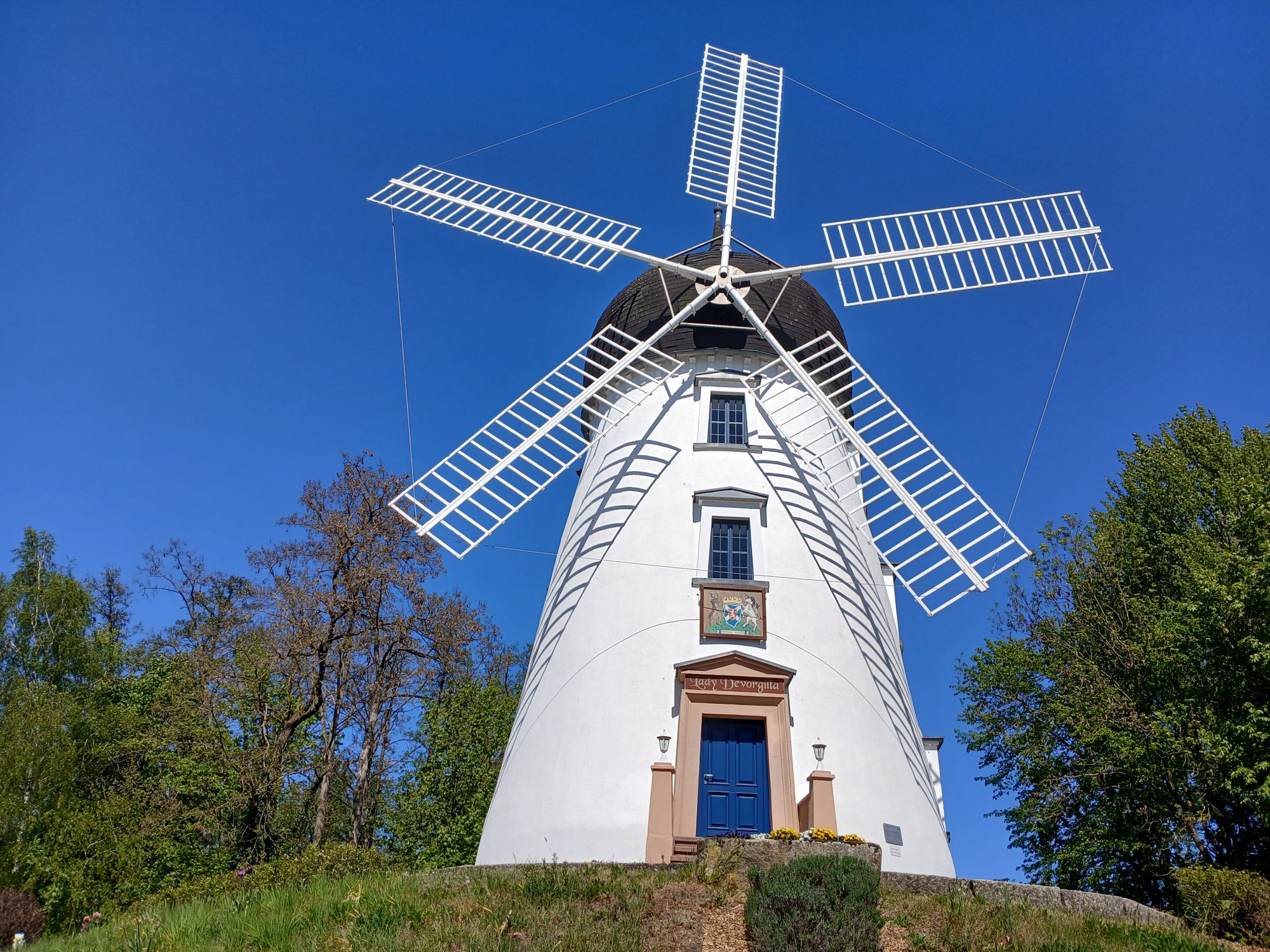 AI generated caption: Traditional white windmill standing under clear blue sky. AI generated caption: Traditional white windmill standing under clear blue sky.