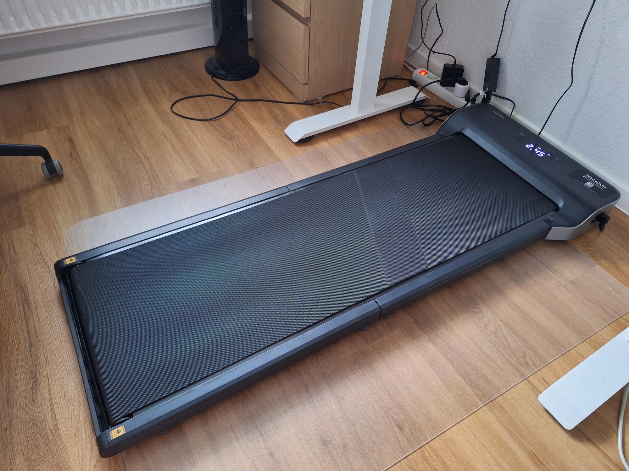 My new walking pad under my standing desk

AI generated caption: Treadmill on wooden floor near desk.